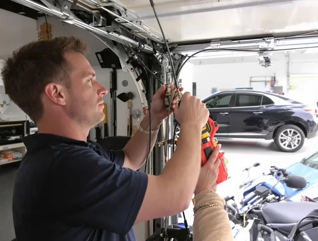 Gainesville Garage Door Repair safety certified technician performing cable replacement in Gainesville